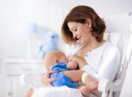 Happy Young Mother With Baby Boy At Home