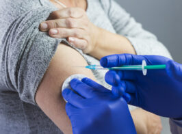 Close Up Doctor S Hand Wearing Blue Gloves Giving Syringe Patient S Arm 23 2148050551